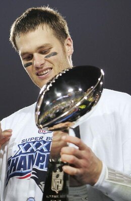JACKSONVILLE, FLORIDA - FEBRUARY 06:  Quarterback Tom Brady #12 of the New England Patriots celebrates with the Lombardi trophy after defeating the Philadelphia Eagles in Super Bowl XXXIX at Alltel Stadium on February 6, 2005 in Jacksonville, Florida.  Th