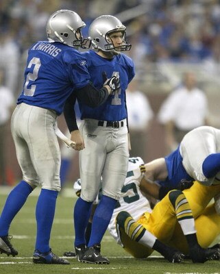 DETROIT, MI - NOVEMBER 27:  Nick Harris #2 of the Detroit Lions congratulates teammate, Jason Hanson #4 after a field goal against the Green Bay Packers on November 27, 2003 at Ford Field in Detroit, Michigan. The Lions won the game, 22-14. (Photo by Tom 