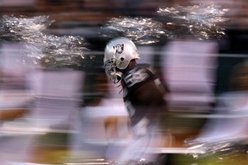 OAKLAND, CA - SEPTEMBER 8:  Defensive end Derrick Burgess #56 of the Oakland Raiders runs onto the field prior to the NFL game against the Denver Broncos on September 8, 2008 at McAfee Coliseum in Oakland, California. The Broncos defeated the Raiders 41-1