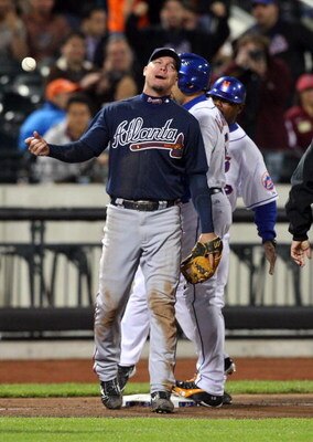 NEW YORK - MAY 12:  Chipper Jones #10 of the Atlanta Braves reacts after Carlos Beltran #15 of the New York Mets was called safe on a ninth inning stolen base at Citi Field May 12, 2009 in the Flushing neighborhood of the Queens borough of New York City. 