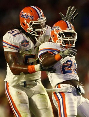 MIAMI - JANUARY 08:  Jermaine Cunningham #21 of the Florida Gators celebrates his interception with teammate Brandon Spikes #51 against the Oklahoma Sooners in the FedEx BCS National Championship Game at Dolphin Stadium on January 8, 2009 in Miami, Florid