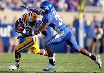 LEXINGTON, KY - OCTOBER 13:  Trindon Holliday #8 of LSU Tigers is tackled by Trevard Lindley #32 of the Kentucky Wildcats during the SEC game at Commonwealth Stadium October 13, 2007 in Lexington, Kentucky. Kentucky won 43-37.  (Photo by Andy Lyons/Getty 