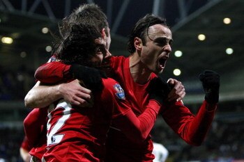 BOLTON, UNITED KINGDOM - JANUARY 17:  Dimitar Berbatov (R) of Manchester United celebrates with team mates Carlos Tevez and Michael Carrick after scoring in the final minutes during the Barclays Premier League match between Bolton Wanderers and Manchester