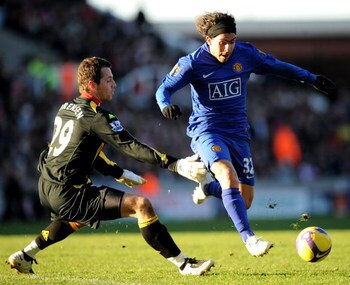 STOKE, UNITED KINGDOM - DECEMBER 26:  Carlos Tevez of Manchester United tries to go past Thomas Sorensen of Stoke City during the Barclays Premier League match between Stoke City and Manchester United at the Britannia Stadium on  December 26, 2008 in Stok