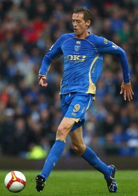PORTSMOUTH, UNITED KINGDOM - APRIL 11:  Peter Crouch of Portsmouth passes the ball during the Barclays Premier League match between Portsmouth and West Bromwich Albion at Fratton Park on April 11, 2009 in Portsmouth, England.  (Photo by Ryan Pierse/Getty 