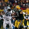 GREEN BAY, WI - NOVEMBER 30:  Aaron Rodgers #12 of the Green Bay Packers runs with the ball under pressure from Julius Peppers #90 of the Carolina Panthers at Lambeau Field on November 30, 2008 in Green Bay, Wisconsin.  (Photo by Jonathan Daniel/Getty Ima