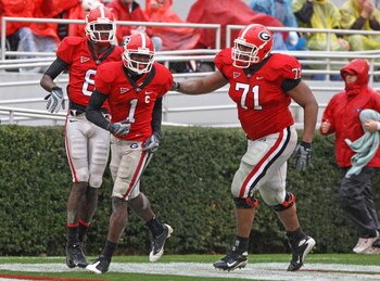 ATHENS, GA - NOVEMBER 29:  Wide receiver A.J. Green #8 (L) and offensive lineman Cordy Glenn #71 (R) of the Georgia Bulldogs congratulate Mohamed Massaquoi #1 after one of his three first half touchdowns during the game against the Georgia Tech Yellow Jac