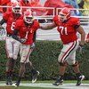 ATHENS, GA - NOVEMBER 29:  Wide receiver A.J. Green #8 (L) and offensive lineman Cordy Glenn #71 (R) of the Georgia Bulldogs congratulate Mohamed Massaquoi #1 after one of his three first half touchdowns during the game against the Georgia Tech Yellow Jac