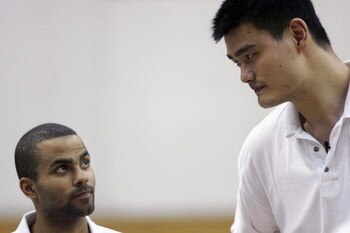 BEIJING - JULY 17: (CHINA OUT) Yao Ming (R), Chinese basketball star and center of Houston Rockets, and Tony Parker (L) from the San Antonio Spurs watch a youth basketball game of 'Basketball Without Borders'activity on July 17, 2005 in Beijing, China. Th