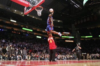 HOUSTON - FEBRUARY 18:  Nate Robinson #4 of the New York Knicks goes up for a dunk over former slam dunk champion Spud Webb in the Sprite Rising Stars Slam Dunk competition during NBA All-Star Weekend at the Toyota Center on February 18, 2006 in Houston, 