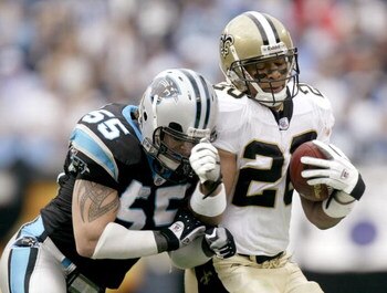 CHARLOTTE, NC - JANUARY 2:  Dan Morgan #55 of the Carolina Panthers knocks Deuce McAllister #26 of the New Orleans Saints out of bounds at Bank of America Stadium on January 2, 2005 in Charlotte, North Carolina. (Photo by Craig Jones/Getty Images)