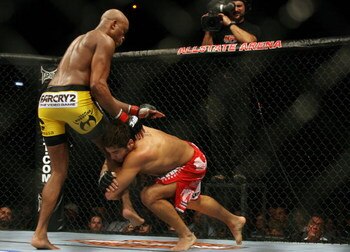 CHICAGO- OCTOBER 25: Anderson Silva (L) wrestles with Patrick Cote  in the Middleweight Title Bout at UFC's Ultimate Fight Night at Allstate Arena on October 25, 2008 in Chicago, Illinois. (Photo by Tasos Katopodis/Getty Images)