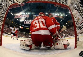 DETROIT - MAY 19:  Martin Havlat #24 of the Chicago Blackhawks celebrates after teammate Jonathan Toews #19 scored a power play goal int he first period against goalie Chris Osgood #30 of the Detroit Red Wings during Game Two of the Western Conference Cha