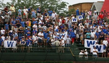 CHICAGO - AUGUST 06: Chicago Cubs fans hold W (win) flags in the left field bleachers after a Cubs victory over the Houston Astros on August 6, 2008 at Wrigley Field in Chicago, Illinois. The Cubs defeated the Astros 11-4. (Photo by Jonathan Daniel/Getty 
