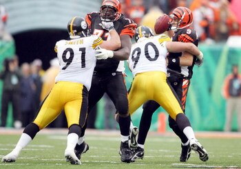 CINCINNATI - OCTOBER 23:  Travis Kirschke #90 of the Pittsburgh Steelers sacks Carson Palmer #9 of the Cincinnati Bengals on October 23, 2005 at Paul Brown Stadium in Cincinnati, Ohio. The Steelers defeated the Bengals 27-13.  (Photo by Andy Lyons/Getty I