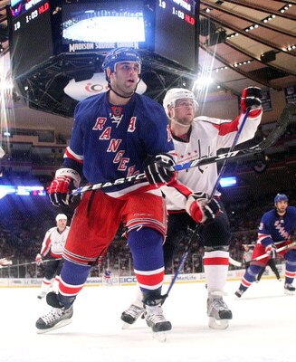 NEW YORK - APRIL 26: Scott Gomez #19 of the New York Rangers skates against Mike Green #52 of the Washington Capitals during Game Six of the Eastern Conference Quarterfinal Round of the 2009 NHL Stanley Cup Playoffs at Madison Square Garden on April 26, 2