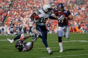 DENVER - SEPTEMBER 14:  Chris Chambers #89 of the San Diego Chargers eludes Calvin Lowry #37 of the Denver Broncos for a 48 yard second quarter touchdown during NFL action at Invesco Field at Mile High on September 14, 2008 in Denver, Colorado.  (Photo by
