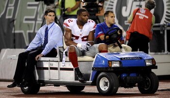 EAST RUTHERFORD, NJ - AUGUST 23:  Osi Umenyiora #92 of the New York Giants leaves the game due to an injury during a preseason NFL game against the New York Jets  at Giants Stadium in the Meadowlands August 23, 2008 in East Rutherford, New Jersey.  (Photo