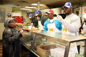 NEW YORK - NOVEMBER 25:  Jeremy Clark, Mathias Kiwanuka, Jerome McDougle, and Justin Tuck of the New York Giants help serve turkeys and fixings to the Community Kitchen of West Harlem on November 25, 2008 in New York City.  (Photo by Scott Gries/Getty Ima