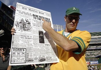 OAKLAND, CA - OCTOBER 6:  A fan of the Oakland A's holds up a replica of the January 6, 1920 edition of the Boston Post, when the Red Sox sold Babe Ruth to the New York Yankees that started the 'curse' in Game 5 of the 2003 American League Divisional Seri