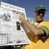 OAKLAND, CA - OCTOBER 6:  A fan of the Oakland A's holds up a replica of the January 6, 1920 edition of the Boston Post, when the Red Sox sold Babe Ruth to the New York Yankees that started the 'curse' in Game 5 of the 2003 American League Divisional Seri