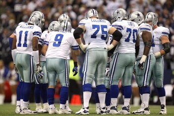 IRVING, TX - DECEMBER 20:  Quarterback Tony Romo #9 of the Dallas Cowboys huddles together with his offense for the play call during their NFL game against the Baltimore Ravens at Texas Stadium on December 20, 2008 in Irving, Texas. The Ravens defeated th
