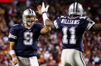 LANDOVER, MD - NOVEMBER 16:  Tony Romo #9 of the Dallas Cowboys celebrates his teams first touchdown against the Washington Redskins with teammate Roy Williams #11 on November 16, 2008 at FedEx Field in Landover, Maryland.  (Photo by Jim McIsaac/Getty Ima