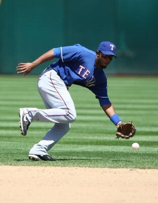 OAKLAND, CA - MAY 07:  Elvis Andrus #1 of the Texas Rangers fields a ball against the Oakland Athletics during a Major League Baseball game on May 7, 2009 at the Oakland Coliseum in Oakland, California.  (Photo by Jed Jacobsohn/Getty Images)