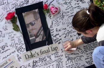 385860 08: A woman signs a condolence card at a makeshift memorial for NASCAR driver Dale Earnhardt, February 21, 2001 at Atlanta Motor Speedway in Hampton, Georgia. Earnhardt was killed February 18, 2001 in a crash on the final lap of the Daytona 500. (P