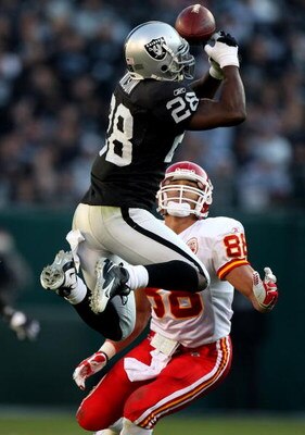 OAKLAND, CA - NOVEMBER 30:  Gibril Wilson #28 of the Oakland Raiders breaks up a pass to Tony Gonzalez #88 of the Kansas City Chiefs during an NFL game on November 30, 2008 at the Oakland-Alameda County Coliseum in Oakland, California.  (Photo by Jed Jaco