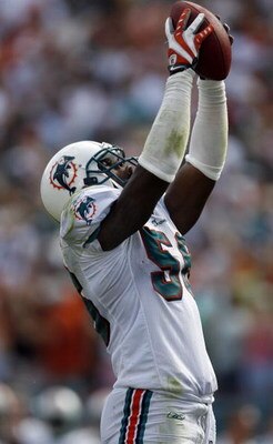 MIAMI - OCTOBER 19: Linebacker Charlie Anderson #56 of the Miami Dolphins celebrates after recovering a ball fumbled by Running back Willis McGahee #23 of the Baltimore Ravens at Dolphin Stadium on October 19, 2008 in Miami, Florida. (Photo by Eliot J. Sc