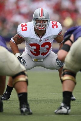 SEATTLE - SEPTEMBER 15:  James Laurinaitis #33 of the Ohio State Buckeyes eyes the line of scrimmage during the game against the Washington Huskies at Husky Stadium on September 15, 2007 in Seattle, Washington. Ohio State won 33-14. (Photo by Otto Greule 