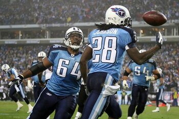 NASHVILLE, TN - JANUARY 10:  Running back Chris Johnson #28 of the Tennessee Titans throws the ball up in the air and celebrates with teammate center Leroy Harris #64 after Johnson scored on an eight yard touchdown run in the first quarter against the Bal