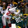 GREEN BAY, WI - JANUARY 20:  Cornerback Corey Webster #23 of the New York Giants intercepts a Brett Favre #4 of the Green Bay Packers pass in front of Donald Driver #80 of the Packers in overtime of the NFC championship game on January 20, 2008 at Lambeau