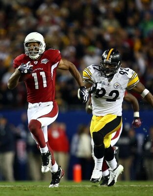 TAMPA, FL - FEBRUARY 01: Larry Fitzgerald #11 of the Arizona Cardinals runs for a touchdown after a catch against James Harrison #92 of the Pittsburgh Steelers in the fourth quarter during Super Bowl XLIII on February 1, 2009 at Raymond James Stadium in