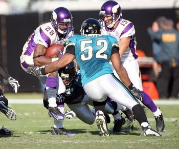JACKSONVILLE, FL - NOVEMBER 23:  Andrian Peterson #28 of the Minnesota Vikings is tackled by Daryl Smith #52 of the Jacksonville Jaguars during the game at Jacksonville Municipal Stadium on November 23, 2008 in Jacksonville, Florida.  (Photo by Sam Greenw