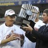 TAMPA, FL - DECEMBER 6: Coach Frank Beamer of the Virginia Tech Hokies takes the winner's trophy from ACC commissioner John Swofford after play against the Boston College Eagles in the 2008 ACC Football Championship game at Raymond James Stadium on Decemb