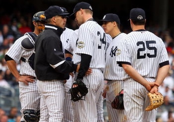 NEW YORK - MAY 17:  Manager Joe Girardi of the New York Yankees talks with A.J. Burnett #34 against the Minnesota Twins on May 17, 2009 at Yankee Stadium in the Bronx borough of New York City. The Yankees defeated the Twins 3-2 in ten innings.  (Photo by 