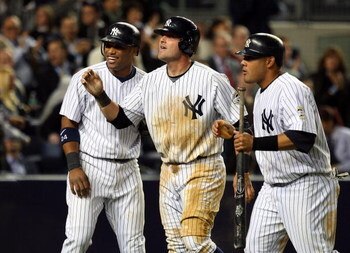 NEW YORK - MAY 19:  (L-R) Robinson Cano #24, Francisco Cervelli #29, and Melky Cabrera #53 of the New York Yankees celebrate after scoring on tammate Derek Jeter's (not pictured) double in the seventh inning against the Baltimore Orioles on May 19, 2009 a