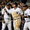 NEW YORK - MAY 19:  (L-R) Robinson Cano #24, Francisco Cervelli #29, and Melky Cabrera #53 of the New York Yankees celebrate after scoring on tammate Derek Jeter's (not pictured) double in the seventh inning against the Baltimore Orioles on May 19, 2009 a