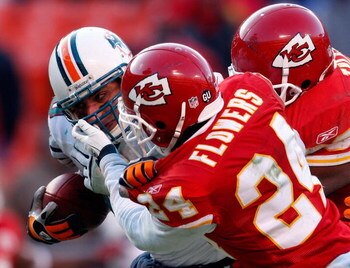 KANSAS CITY, MO - DECEMBER 21:  Receiver Anthony Fasano #80 of the Miami Dolphins lunges for the end-zone scoring the game-winning touchdown as Tank Tyler #93 and Brandon Flowers #24 of the Kansas City Chiefs defend during the game on December 21, 2008 at