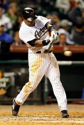 HOUSTON - APRIL 06:  Miguel Tejada #10 of the Houston Astros gets a hit against the Chicago Cubs during the Opening Day game on April 6, 2009 at Minute Maid Park in Houston, Texas.  (Photo by Chris Graythen/Getty Images)