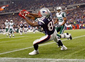 FOXBORO, MA - NOVEMBER 13:  Randy Moss #81 of the New England Patriots catches a touchdown pass against the defense of Ty Law #22 and Kerry Rhodes #25 of the New York Jets, sending the game to overtime at Gillette Stadium on November 13, 2008 in Foxboro, 
