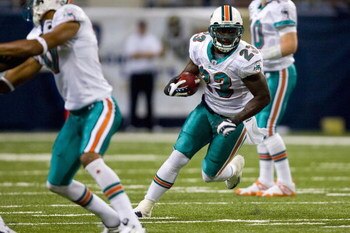 ST. LOUIS, MO. - NOVEMBER 30:  Ronnie Brown #23 of the Miami Dolphins rushes against the St. Louis Rams at the Edward Jones Dome on November 30, 2008 in St. Louis, Missouri.  (Photo by Dilip Vishwanat/Getty Images)