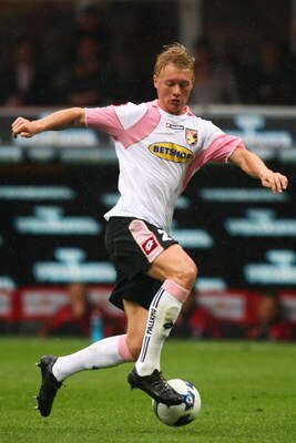MILAN, ITALY - APRIL 26:  Simon Kjaer of Palermo runs with the ball during the Serie A match between AC Milan and US Citta di Palermo at the San Siro Stadium on April 26, 2009 in Milan, Italy.  (Photo by Michael Steele/Getty Images)
