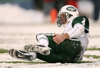 SEATTLE - DECEMBER 21:  Quarterback Brett Favre #4 of the New York Jets gets back up after being tackled by Brandon Mebane of the Seattle Seahawks on the final possession on December 21, 2008 at Qwest Field in Seattle, Washington. The Seahawks defeated th