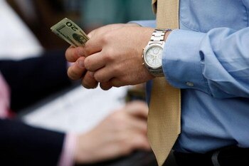 LOUISVILLE, KY - MAY 02:  A race fan holds money during the 135th running of the Kentucky Derby on May 2, 2009 at Churchill Downs in Louisville, Kentucky.  (Photo by Jamie Squire/Getty Images)