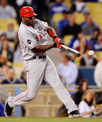 LOS ANGELES, CA - MAY 23:  Torii Hunter of the Los Angeles Angels of Anaheim hits a single off pitcher Randy Wolf of the Los Angeles Dodgers during the baseball game at Dodger Stadium on May 23, 2009 in Los Angeles, California.  (Photo by Kevork Djansezia