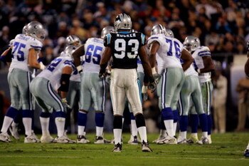 HARLOTTE, NC - OCTOBER 29:  Defensive end Mike Rucker #93 of the Carolina Panthers waits at the line of scrimmage as the Dallas Cowboys huddle during the game on October 29, 2006 at Bank of America Stadium in Charlotte, North Carolina. The Cowboys won 35-