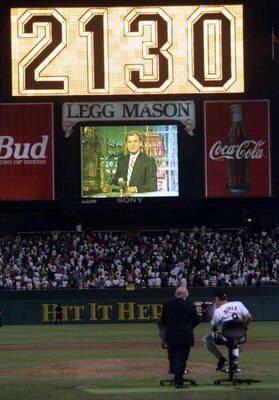 5 Sep 1995:  Shortstop Cal Ripken of the Baltimore Orioles  (right) watches a screen on which David Letterman appears to commerorate Ripken tying Lou Gehrig''s record for number of consecutive games played at 2130.  The game was between the Orioles and th